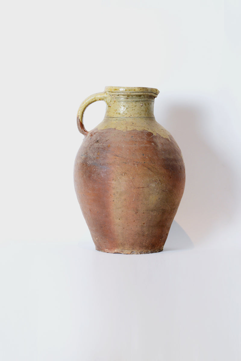 Tall antique jug with handle